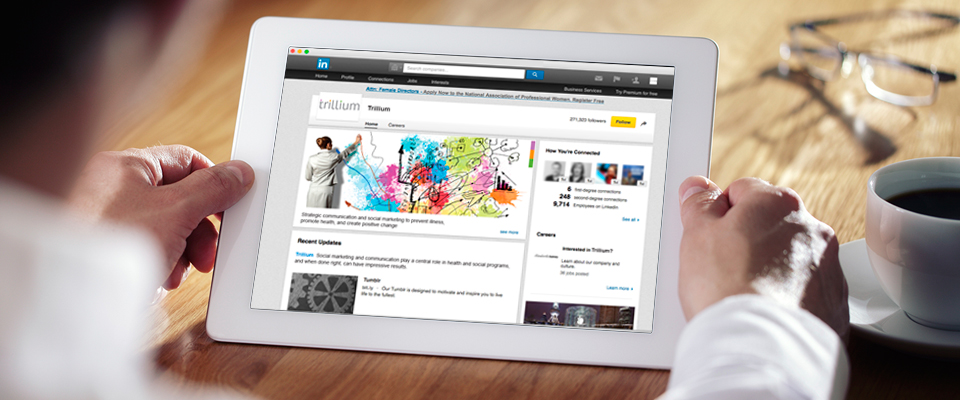 Trillium company LinkedIn page shown on an iPad. The social media profile page shows brand elements that make up the Trillium visual branding system.
